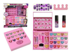 A set of beauty products. A large palette of shadows, lipsticks, nail polishes
